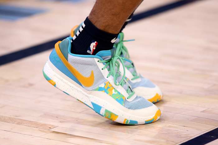 View of Ja Morant's blue and yellow Nike shoes.